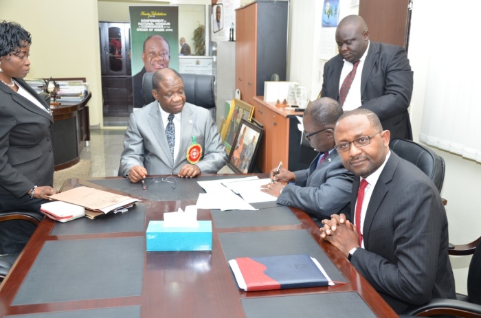 Ike Nwabuonwu, Chairman & CEO of Alpha Energy and Electric, Inc., Kansas City, Missouri, USA signing the MoU on December 16, 2014 for development of Rural Off-Grid Solar Electrification, Off-Grid (Embedded) and Grid-Connected Electricity in Nigeria