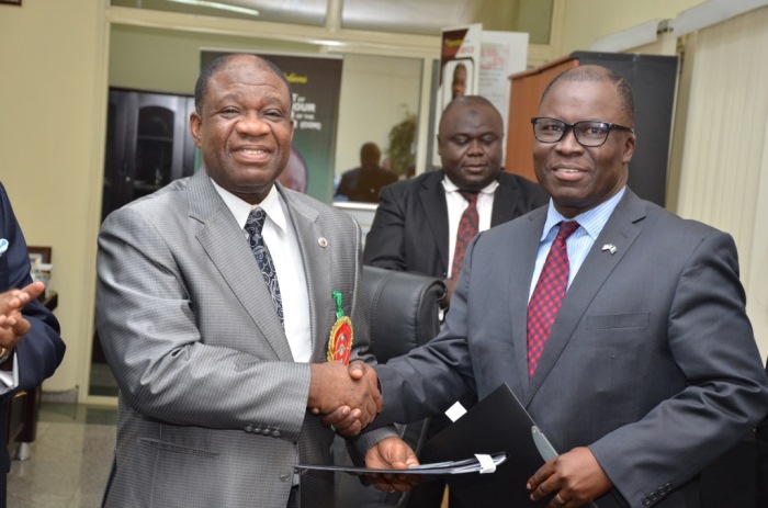 The Minister of Power, Chinedu Nebo (Professor) and Ike Nwabuonwu, Chairman & CEO of Alpha Energy & Electric, Inc. after signing the MoU on December 16, 2014 for development of Rural Off-Grid Solar Electrification, Off-Grid (Embedded) and Grid-Connected Electricity in Nigeria